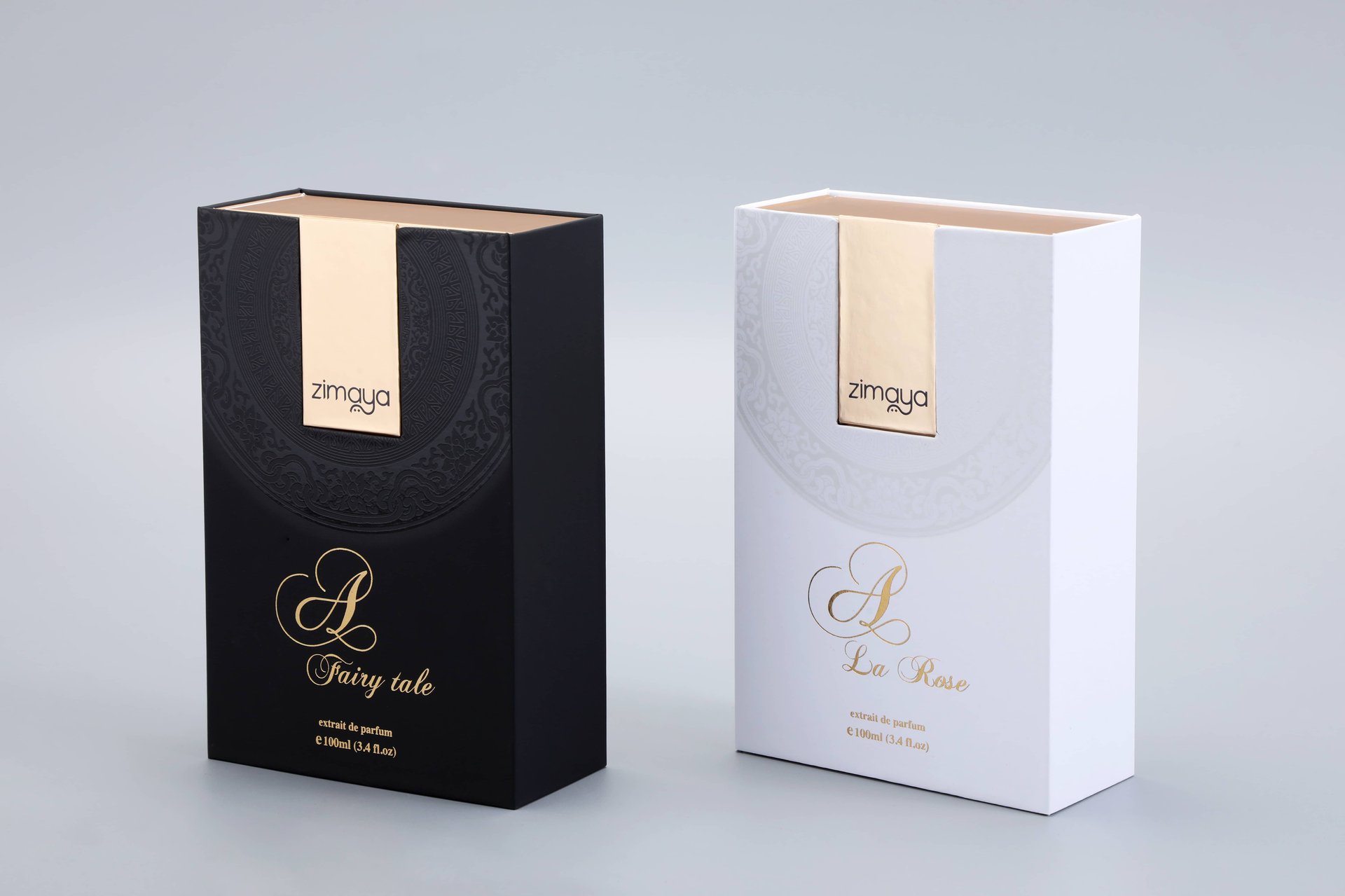 Two elegantly designed custom boxes for perfume: one featuring a sleek black design with sophisticated gold accents, and the other showcasing a pristine white design also enhanced with luxurious gold details. Both are set against a plain background to highlight their refined aesthetics and craftsmanship.